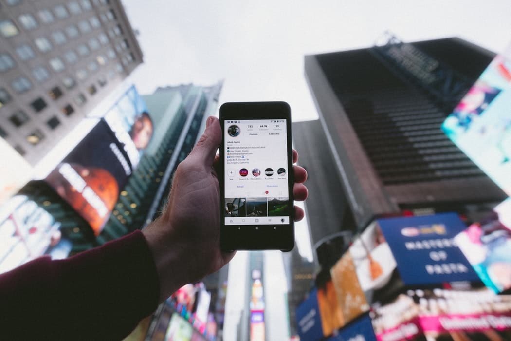 un homme montre son profil instagram à New York